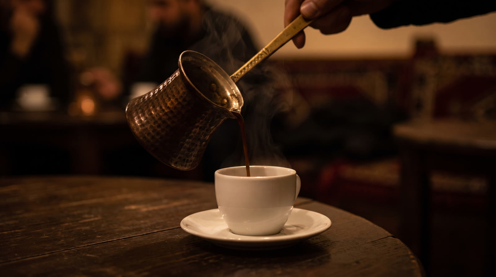 Lebanese coffee poured from a copper rakweh into a small cup